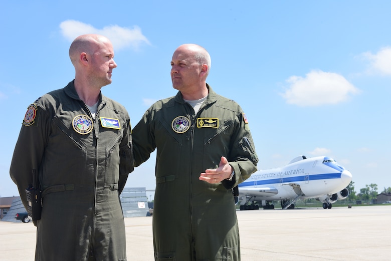 Brig. Gen. Christopher Coffelt, right, the deputy director of Nuclear Operations at U.S. Strategic Command, congratulations Capt. Paul Bouvier, left, an Airborne Launch Control System intelligence officer and strike planner at the 625th Strategic Operations Squadron, left, on reaching his 400th alert with the squadron at Offutt Air Force Base, Nebraska, May 21, 2018. Pulling alert involves standing by to react to incoming strategic attacks on the United States, which in Bouvier’s case, takes place on the U.S. Navy E-6B. (U.S. Air Force photo by Staff Sgt. Rachel Hammes)