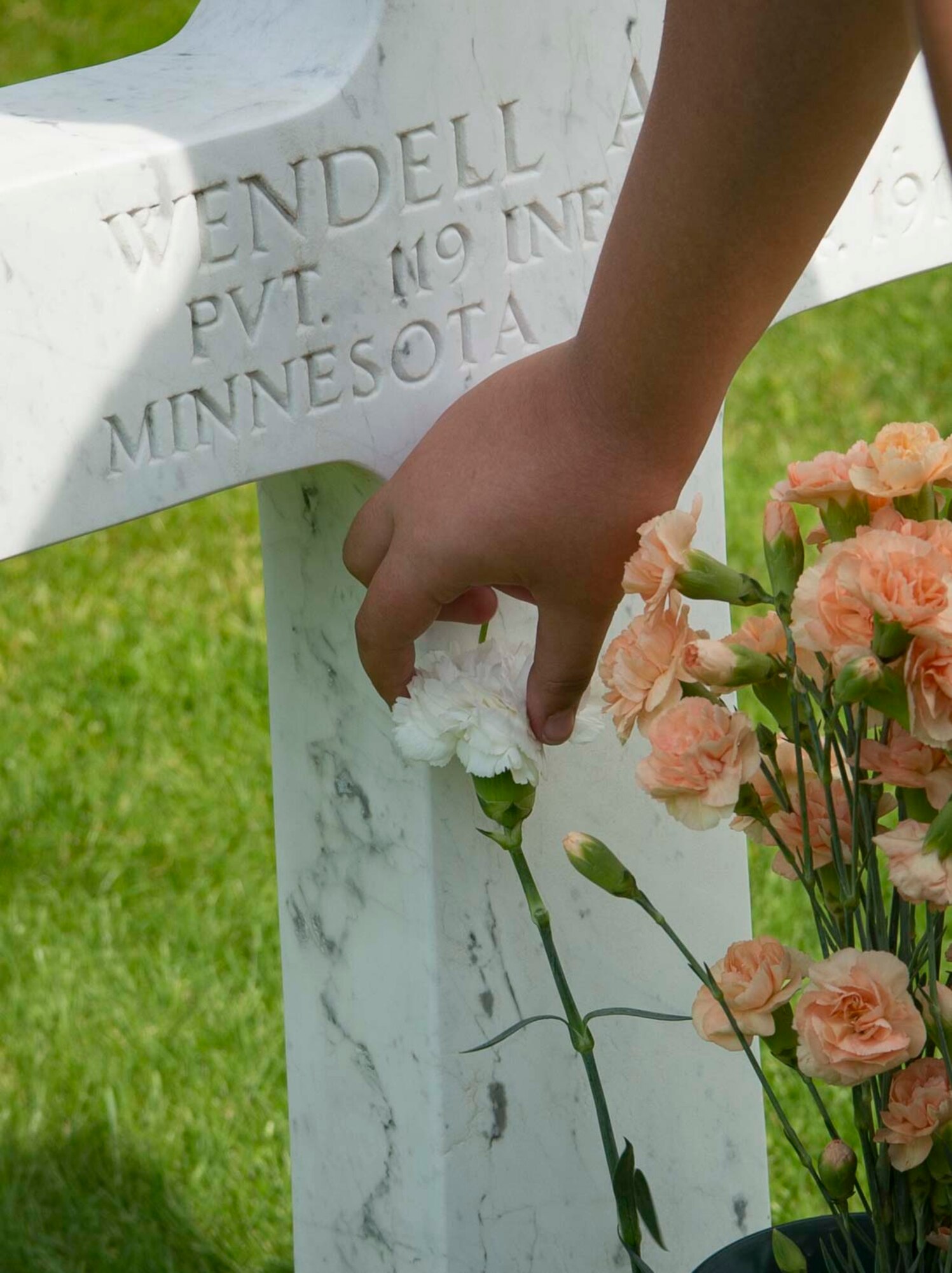 School children from the Municipality of Waregem lay flowers on grave sites at Flanders Field American Cemetery, Belgium, May 27, 2018. Flanders Field was a major battle theatre during World War I, where approximately 1 million soldiers from more than 50 countries became wounded, missing, or killed in action. (U.S. Air Force photo by Senior Airman Elizabeth Baker)