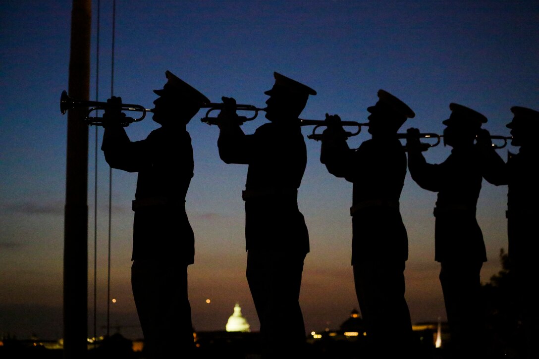 Marines with “The Commandant’s Own” U.S. Marine Drum & Bugle Corps play Taps during a Friday Evening Parade at Marine Barracks Washington D.C., May 25, 2018. The guests of honor for the parade were Gold Star Families and the hosting official was Lieutenant Gen. Robert S. Walsh, commanding general, Marine Corps Combat Development Command, and deputy commandant, Combat Development and Integration. (Official Marine Corps photo by Cpl. Damon Mclean/Released)