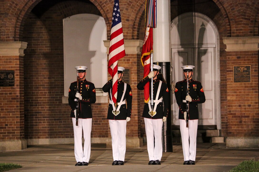 Marines with the U.S. Marine Corps Color Guard render rifle salutes during a Friday Evening Parade at Marine Barracks Washington D.C., May 25, 2018. The guests of honor for the parade were Gold Star Families and the hosting official was Lieutenant Gen. Robert S. Walsh, commanding general, Marine Corps Combat Development Command, and deputy commandant, Combat Development and Integration. (Official Marine Corps photo by Cpl. Damon Mclean/Released)