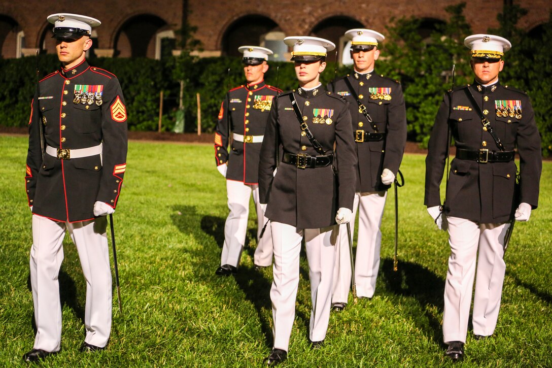 Marines with the Marine Barracks Washington D.C. parade staff conduct pass in review during a Friday Evening Parade at Marine Barracks Washington D.C., May 25, 2018. The guests of honor for the parade were Gold Star Families and the hosting official was Lieutenant Gen. Robert S. Walsh, commanding general, Marine Corps Combat Development Command, and deputy commandant, Combat Development and Integration. (Official Marine Corps photo by Cpl. Damon Mclean/Released)