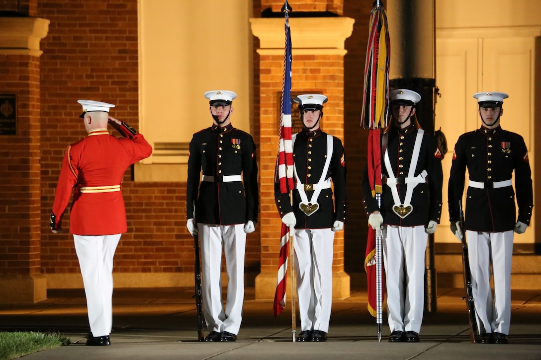 Captain James D. Foley, executive officer, “The Commandant’s Own” U.S. Marine Drum & Bugle Corps, salutes the National Ensign and the U.S. Marine Corps Battle Colors on Center Walk during a Friday Evening Parade at Marine Barracks Washington D.C., May 25, 2018. The guests of honor for the parade were Gold Star Families and the hosting official was Lieutenant Gen. Robert S Walsh, commanding general, Marine Corps Combat Development Command, and deputy commandant, Combat Development at Integration. (Official photo by Marine Corps Pfc. James Bourgeois/Released)