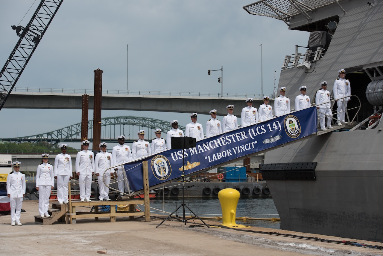 The crew of the littoral combat ship USS Manchester man the rails during the ship's commissioning ceremony in Portsmouth, N.H.