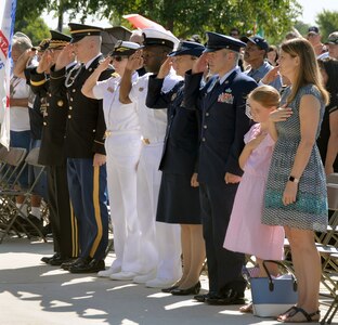 Local Joint Base San Antonio military leaders salute the colors, presented by members of the Southside High School Junior Air Force ROTC Honor Guard, during the Memorial Day ceremony at the Fort Sam Houston National Cemetery amphitheater May 28.