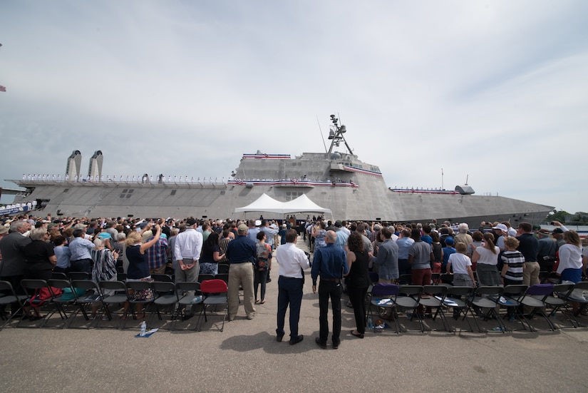 The crew of the littoral combat ship USS Manchester man the rails during the vessel’s commissioning ceremony in Manchester, N.H.