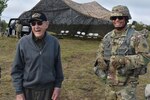 WWII veteran Charlie Brown, who served with the 258th Field Artillery, arrives on in the training site of Fort Drum, Watertown, N.Y., May 23, 2018. Brown was a guest of the 258 during their annual training, and would be pulling the lanyard on the first M777 howitzer to fire.