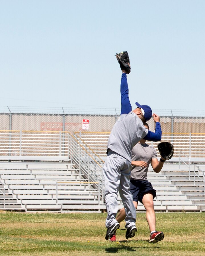 Staff Sgt. Pedro Villa, S-1, leaps to catch a long-shot softball during a Marine pick up game held on Sorenson Field aboard Marine Corps Logistics Base Barstow, Calif., May 25. The game, along with a barbeque were a way to kick off Memorial Day Weekend and build camaraderie.