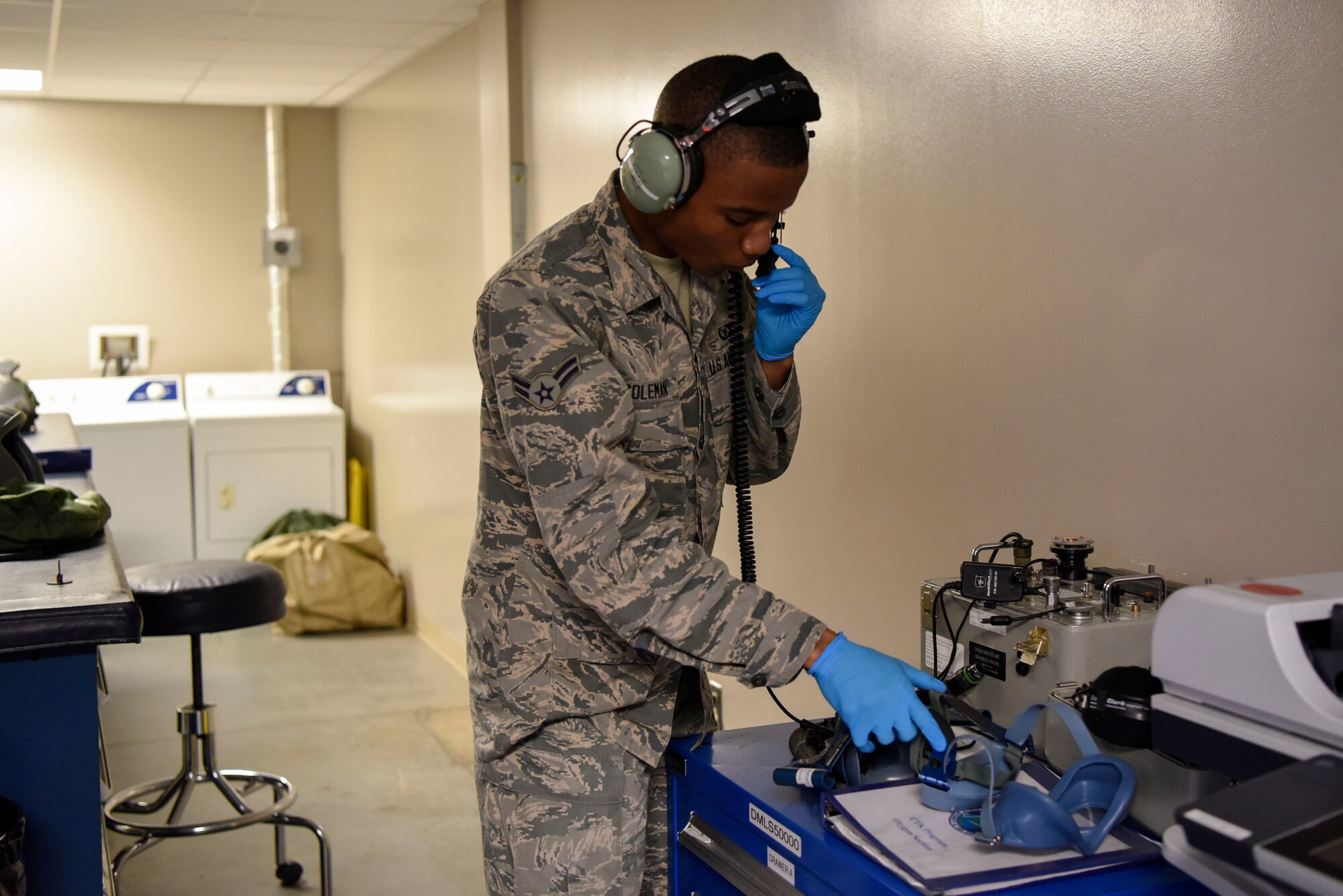 Airman 1st Class David Coleman, 436th Operations Support Squadron aircrew flight equipment apprentice, tests the microphone of a headset May 23, 2018, at Dover Air Force Base, Del. The headsets are used for easy communication between aircrew members during a flight. (U.S Air Force photo by Airman 1st Class Zoe M. Wockenfuss)