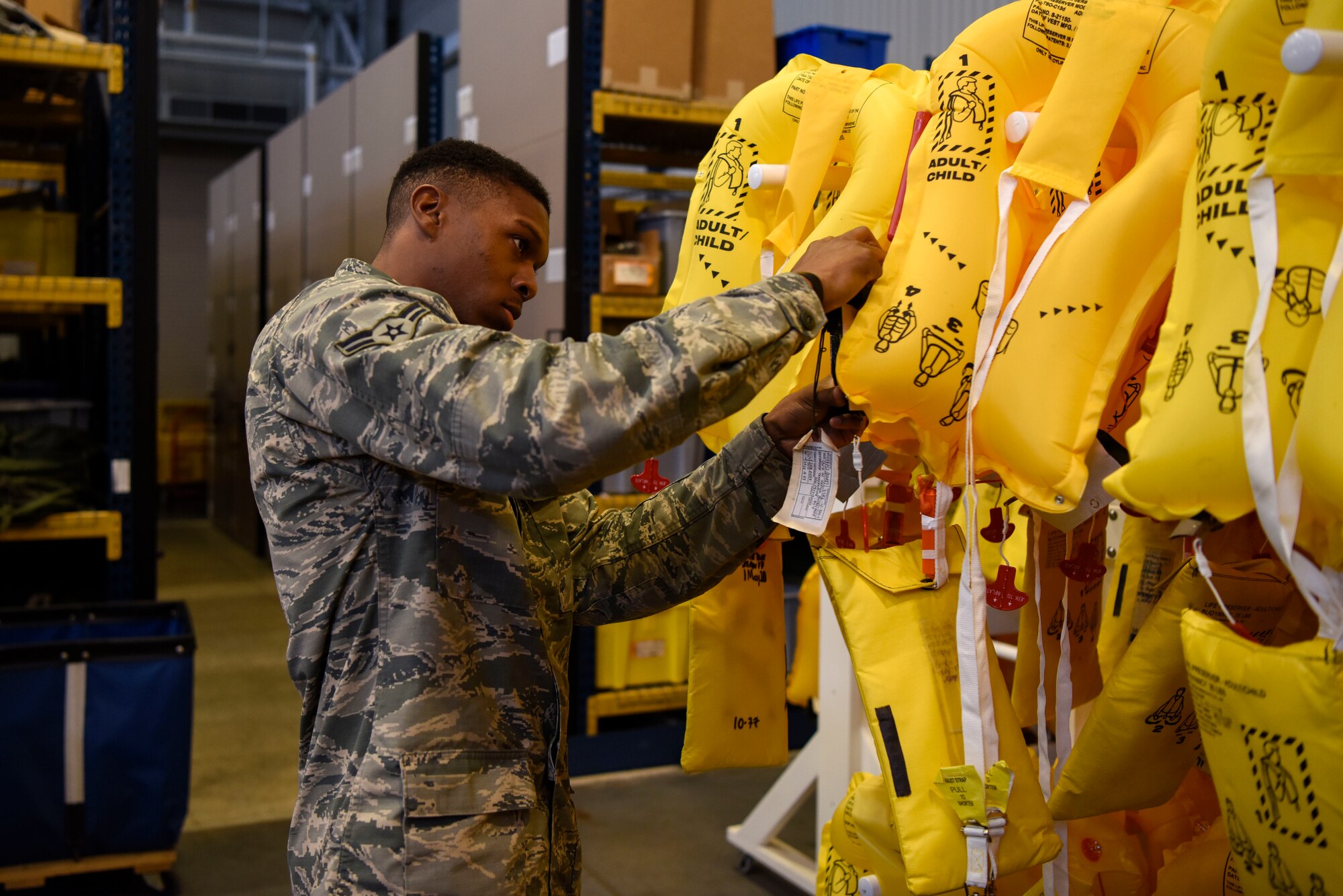 Airman 1st Class Anthony Gray, 436th Operations Support Squadron aircrew flight equipment apprentice, tests inflatable life preservers May 23, 2018, at Dover Air Force Base, Del. The life preservers are provided for the aircrew and any passengers who may be onboard. (U.S Air Force photo by Airman 1st Class Zoe M. Wockenfuss)