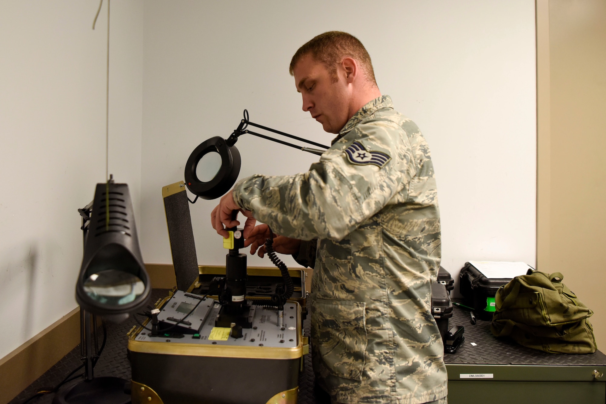Staff Sgt. Chris Sharlow, 436th Operations Support Squadron aircrew flight equipment craftsman, runs tests on night vision goggles May 23, 2018, at Dover Air Force Base, Del. Aircrews use NVGs to significantly improve visibility in low light condition missions. (U.S Air Force photo by Airman 1st Class Zoe M. Wockenfuss)