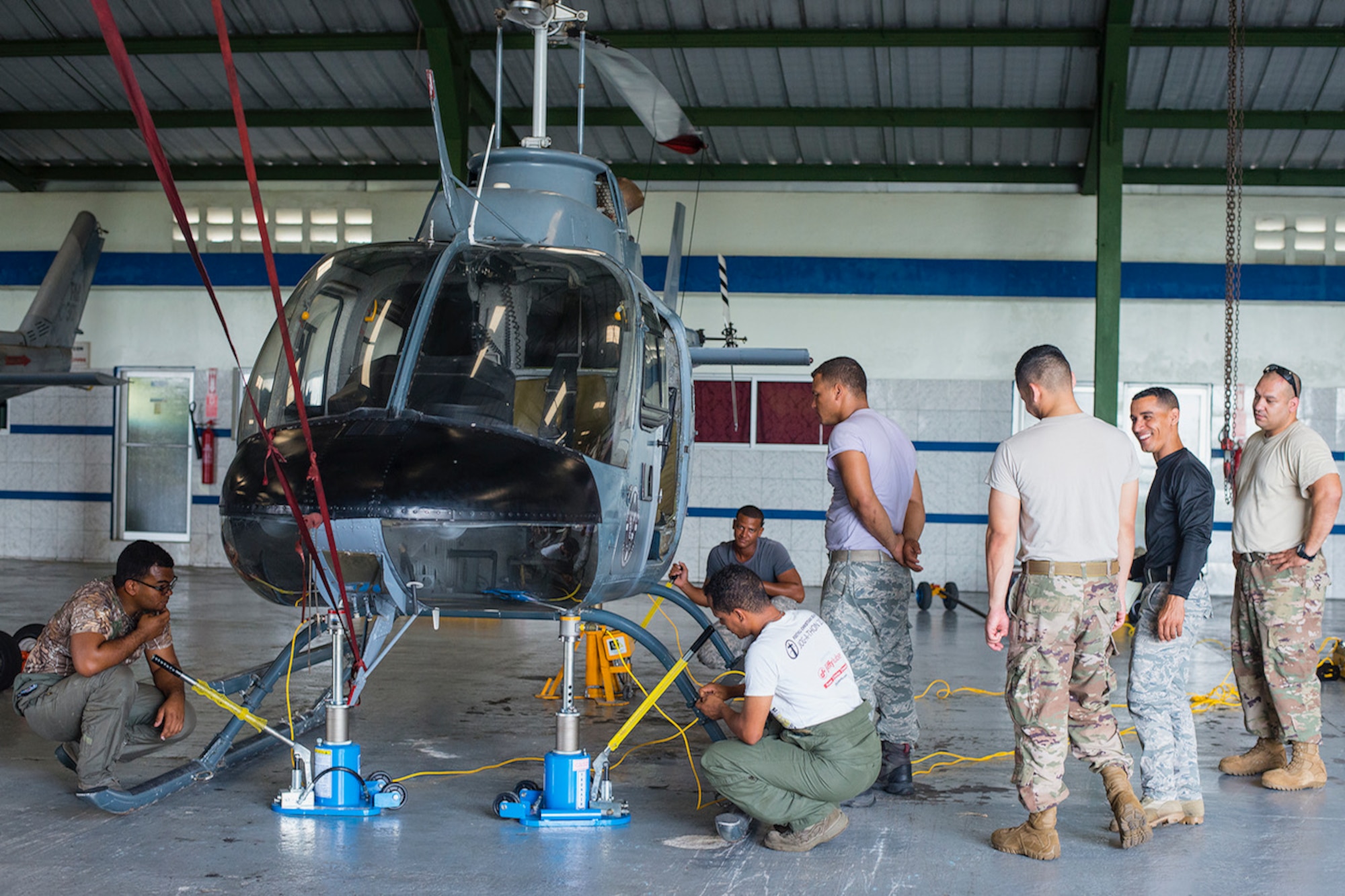 Air advisors from the 571st Air Mobility Advisory Squadron oversee students from the Dominican Republic Air Force as they practice weight and balance positions on a helicopter at the San Isidro Air Base, Dominican Republic, May 3. The MSAS team trained members of the FARD on aircraft weight and balance, corrosion control, hazardous materials management and radio communications.  They also conducted an assessment of vehicle maintenance and operations. (U.S. Air Force photo by Staff Sgt. Heather Flitcroft)