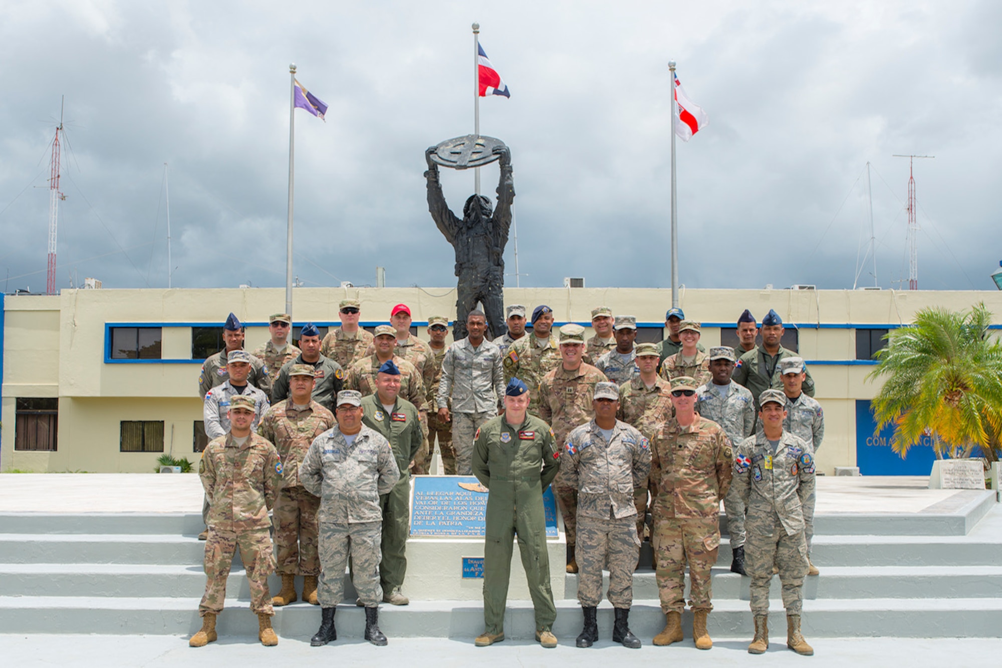 Military members from the 571st Air Mobility Advisory Squadron and the Dominican Republic Air Force pose for a photo in front of the headquarters building at the San Isidro Air Base, Dominican Republic, May 4. The MSAS team trained members of the FARD on aircraft weight and balance, corrosion control, hazardous materials management and radio communications.  They also conducted an assessment of vehicle maintenance and operations. (U.S. Air Force photo by Staff Sgt. Heather Flitcroft)