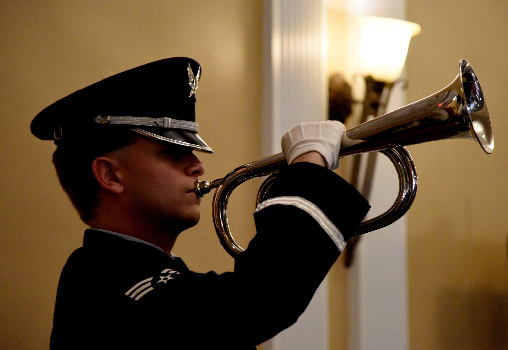 U.S. Air Force Senior Airman Vincent Beard, Keesler Honor Guard member, plays Taps during the Memorial Day Ceremony at the Biloxi National Cemetery, Biloxi, Mississippi, May 28, 2018. The ceremony honored those who have made the ultimate sacrifice while serving in the armed forces. (U.S. Air Force photo by Kemberly Groue)