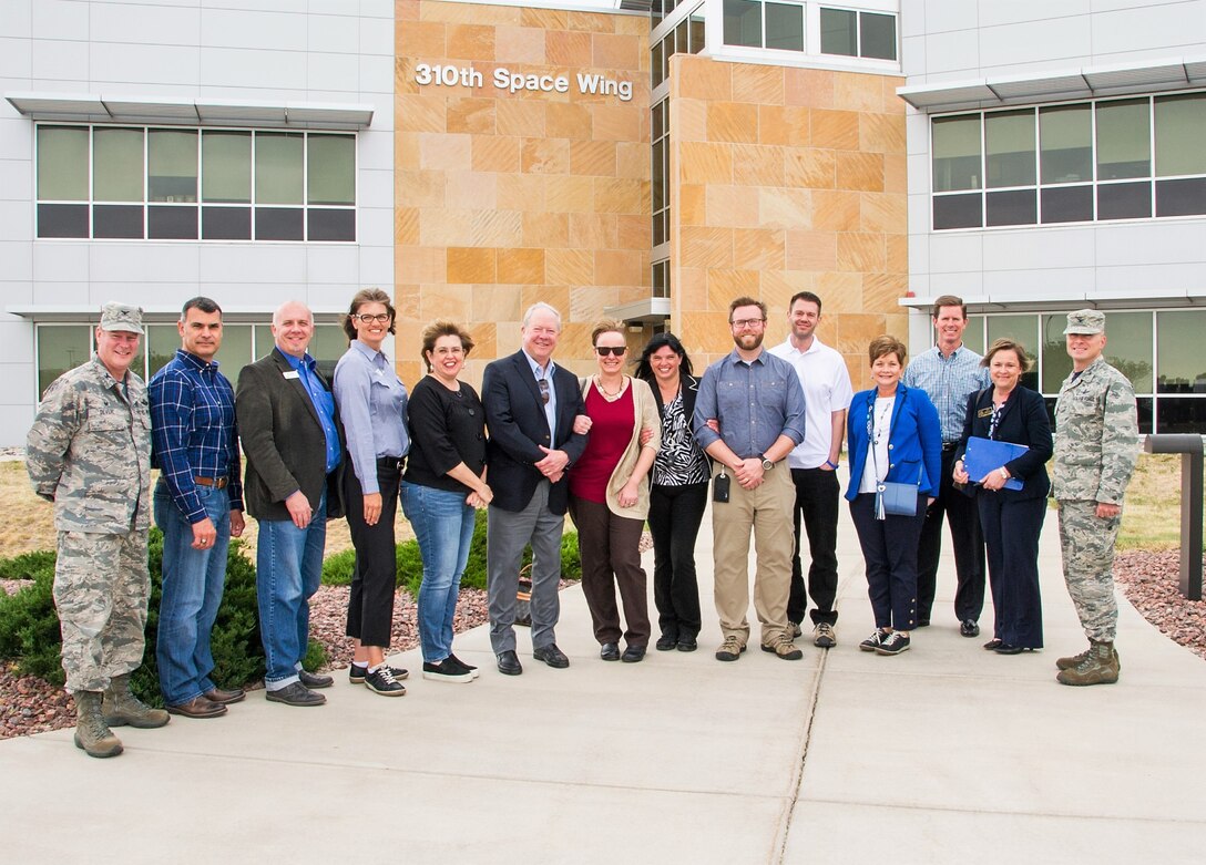Col. James DeVere, left, 302nd Airlift Wing commander, and Col. Darren Buck, right, 310th Space Wing vice commander, pose for a photo with community leaders taking part in the 302nd AW’s Partners in Leadership program after touring the 19th and 6th Space Operations Squadrons at Schriever Air Force Base, Colorado, May 18, 2018. During the tour of the only Reserve space wing in the Air Force, community leaders learned about the Global Positioning System and the Defense Meteorological Satellite Program. The 302nd AW Partners in Leadership program is designed to educate local community leaders on Air Force Reserve mission sets and Reserve partnerships with active duty organizations in the local area throughout 2018. (U.S. Air Force photos/Staff Sgt. Laura Turner)