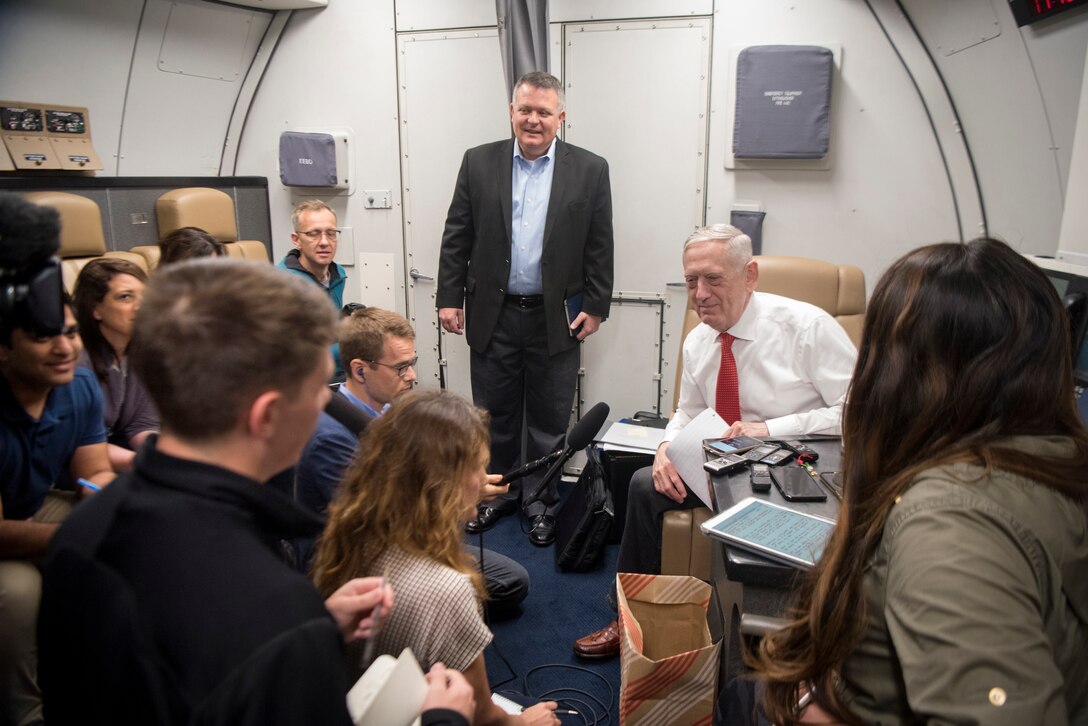 Defense Secretary James N. Mattis speaks with reporters on a plane.