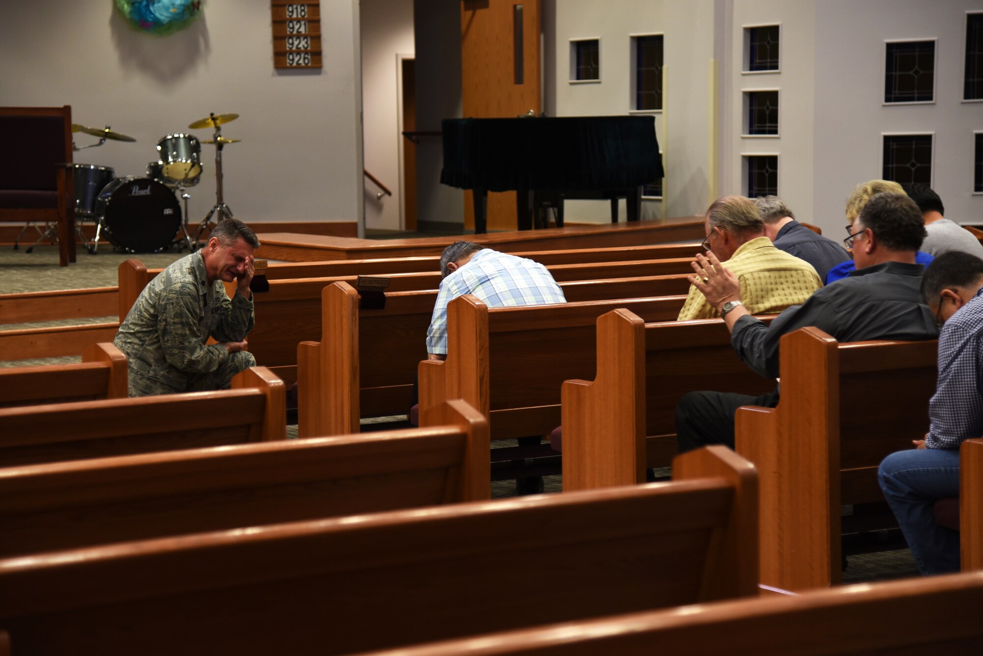 U.S. Air Force Lt. Col. Robert Borger, 17th Training Wing chaplain, kneels for an open prayer session during Clergy Day at the Taylor Chapel on Goodfellow Air Force Base, Texas, May 24, 2018. Borger gathered 25 local pastors to teach them about Goodfellow, its mission and its service members. (U.S. Air Force photo by Staff Sgt. Joshua Edwards/Released)