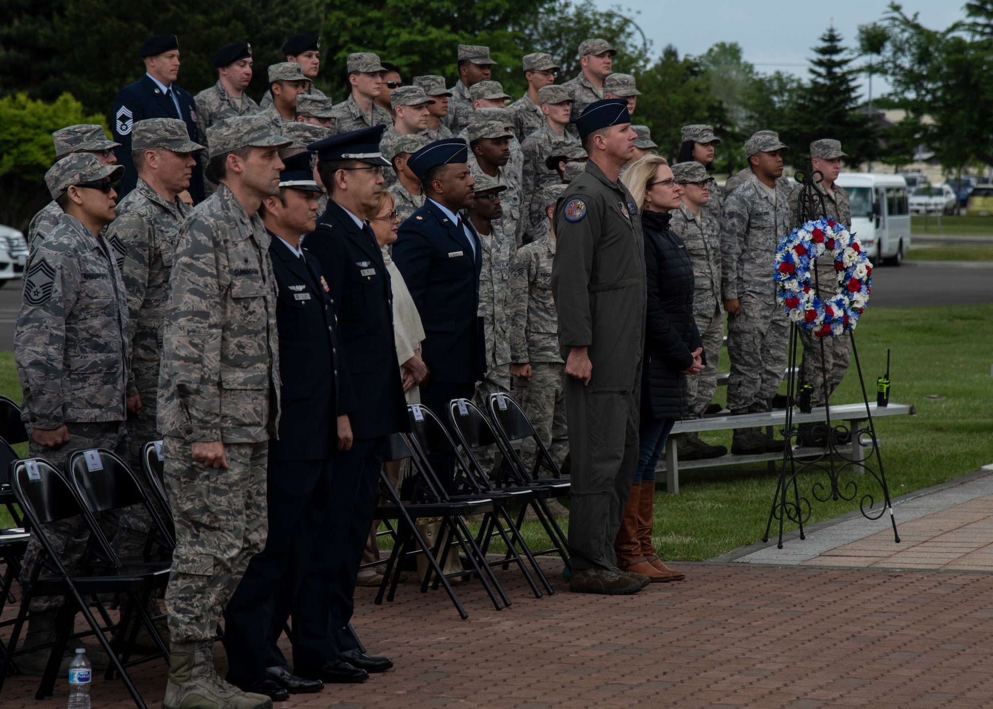 Team Misawa members stand at attention during a Memorial Day ceremony held at Misawa Air Base, Japan, May 25, 2018. Memorial Day is an American holiday, observed on the last Monday of May, honoring the men and women who died while serving in the U.S. military. (U.S. Air Force photo by Airman 1st Class Collette Brooks)