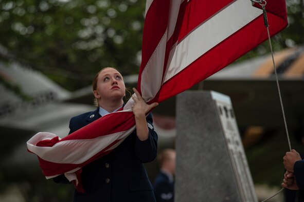 U.S. Air Force Senior Airman Sarah Rose, a 35th Maintenance Squadron electrical and environmental apprentice, holds the American Flag during a Memorial Day ceremony held at Misawa Air Base, Japan, May 25, 2018. It is customary for the flag to be lowered during the ceremony to remember and pay respect to fallen service members. (U.S. Air Force photo by Airman 1st Class Collette Brooks)