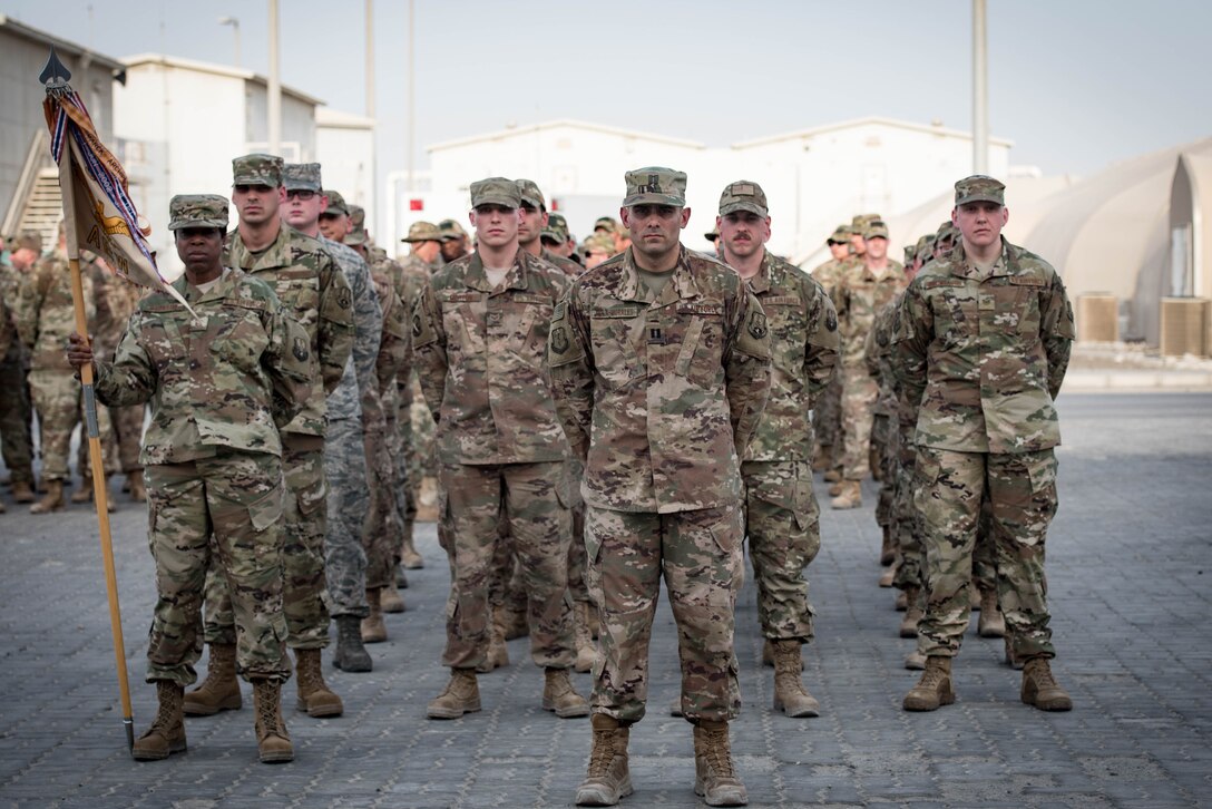Members deployed to Al Dhafra Air Base stand in formation during a Memorial Day retreat ceremony at the 380th Air Expeditionary Wing headquarters, May 28, 2018. The ceremony honored all fallen service members with a flag retirement ceremony and words from leadership. (U.S. Air Force photo by Staff Sgt. Erica Rodriguez)