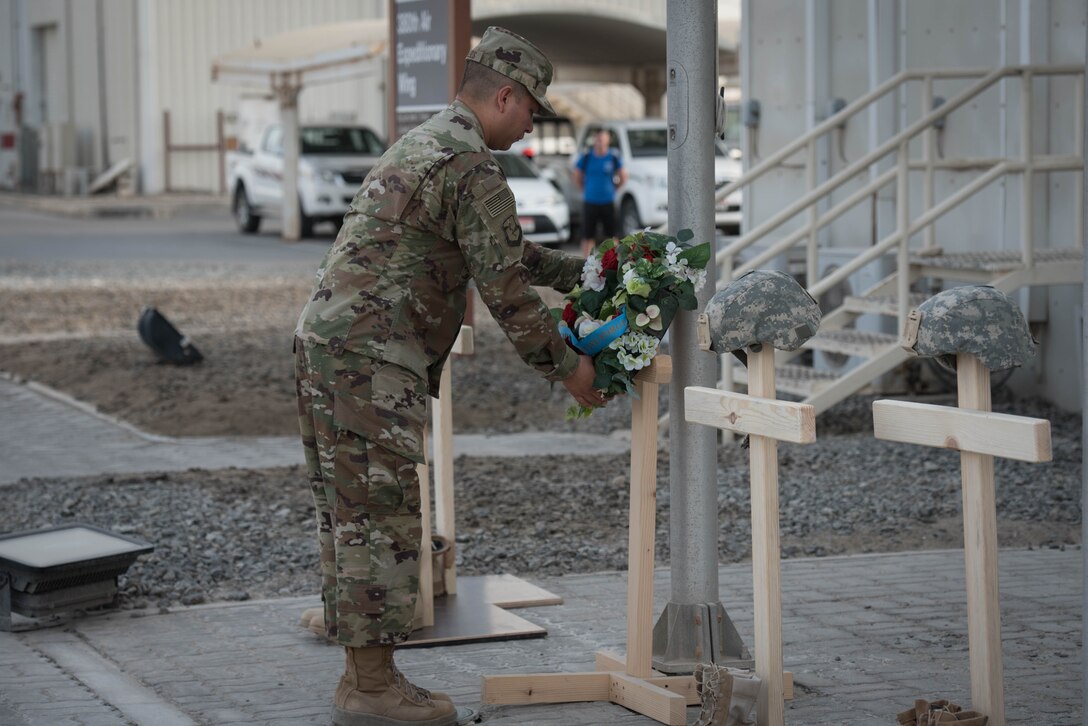 Air Force Tech. Sgt. Jonathan Robles, 380th Air Expeditionary honor guard NCOIC, lays a wreath during a Memorial Day retreat ceremony at the 380th Air Expeditionary Wing headquarters, May 28, 2018. The ceremony honored all fallen service members with a flag retirement ceremony and words from leadership. (U.S. Air Force photo by Staff Sgt. Erica Rodriguez)