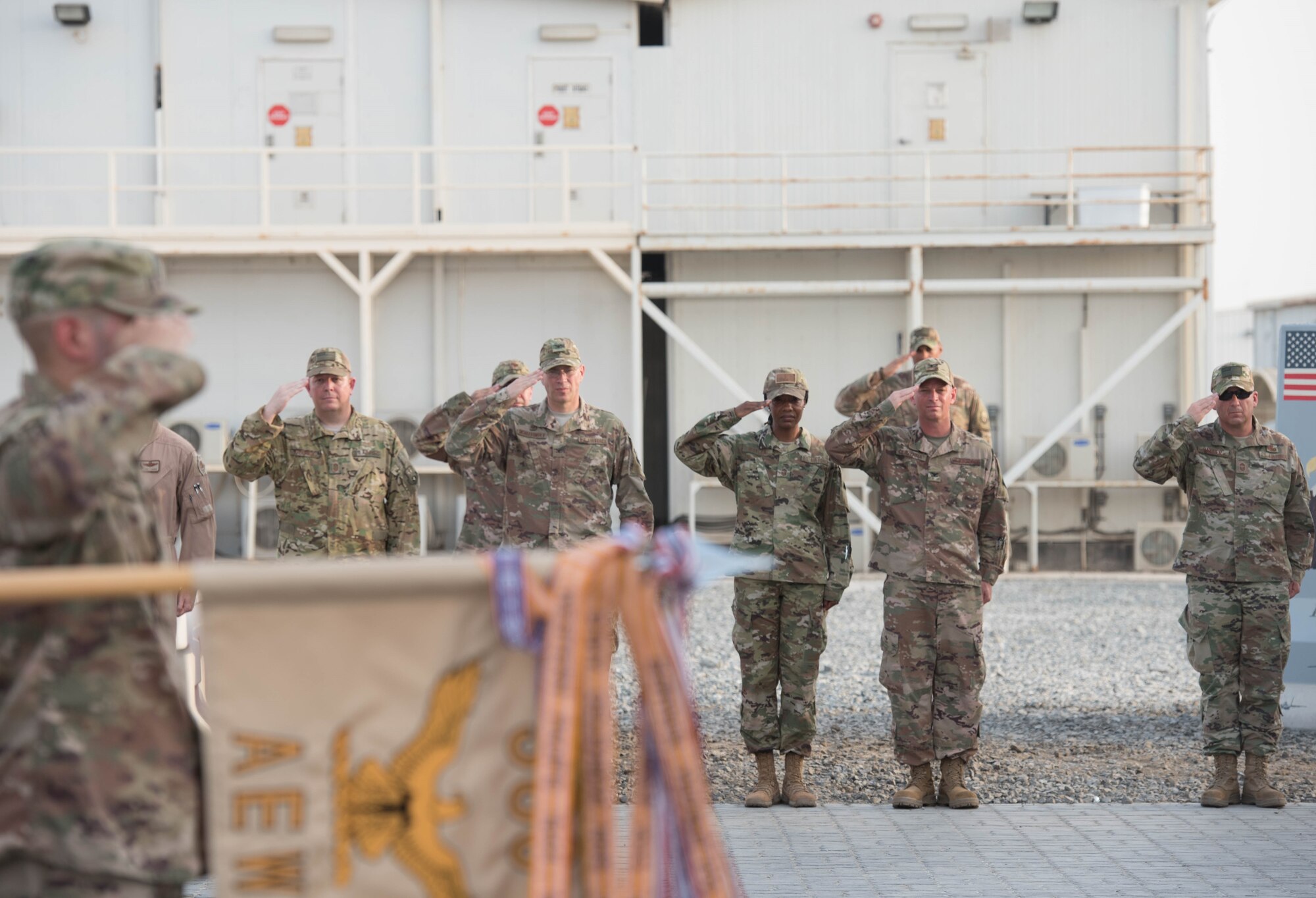 Members deployed to Al Dhafra Air Base stand in formation during a Memorial Day retreat ceremony at the 380th Air Expeditionary Wing headquarters, May 28, 2018. The ceremony honored all fallen service members with a flag retirement ceremony and words from leadership. (U.S. Air Force photo by Staff Sgt. Erica Rodriguez)