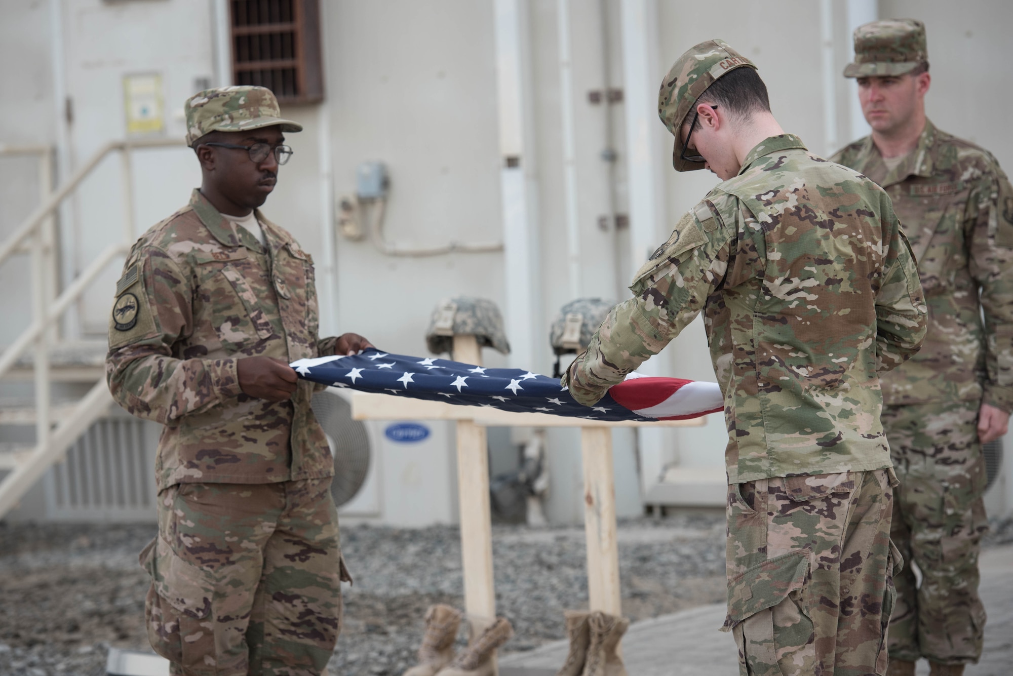 The 380th Air Expeditionary Wing honor guard complete a flag folding during a Memorial Day retreat ceremony at the 380th Air Expeditionary Wing headquarters, May 28, 2018. The ceremony honored all fallen service members with a flag retirement ceremony and words from leadership. (U.S. Air Force photo by Staff Sgt. Erica Rodriguez)