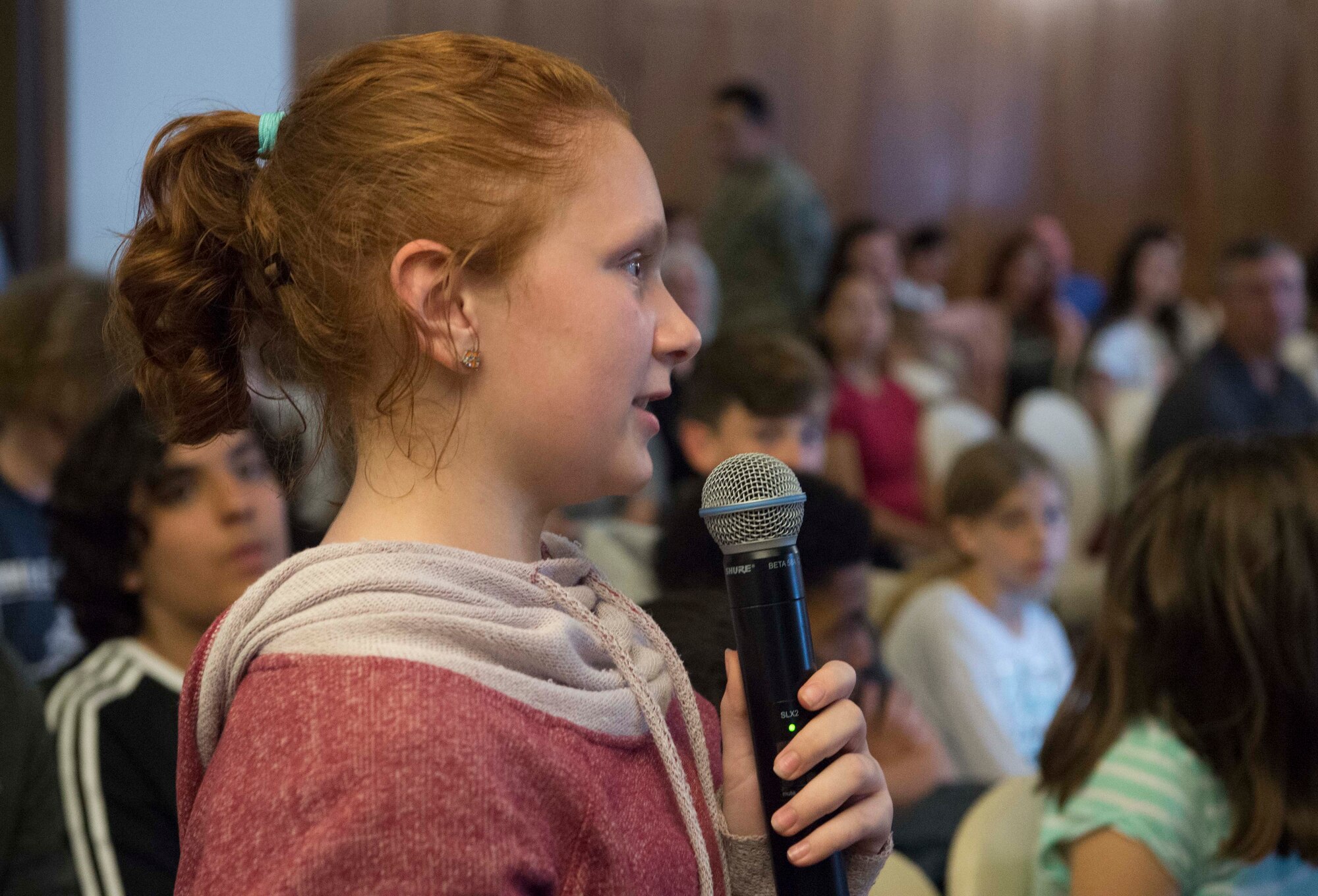 A Ramstein Air Base student asks Joan Salter, Holocaust survivor, a question during the 86th Airlift Wing Holocaust Remembrance on Ramstein Air Base, Germany, May 24, 2018. Salter was an honored guest who spoke about her life as a polish Jew growing up under oppression in western Europe. The 86th AW hosted the Holocaust Remembrance to honor the memory, culture and history of the estimated 11 million who were killed during the Holocaust. (U.S. Air Force photo by Senior Airman Elizabeth Baker)
