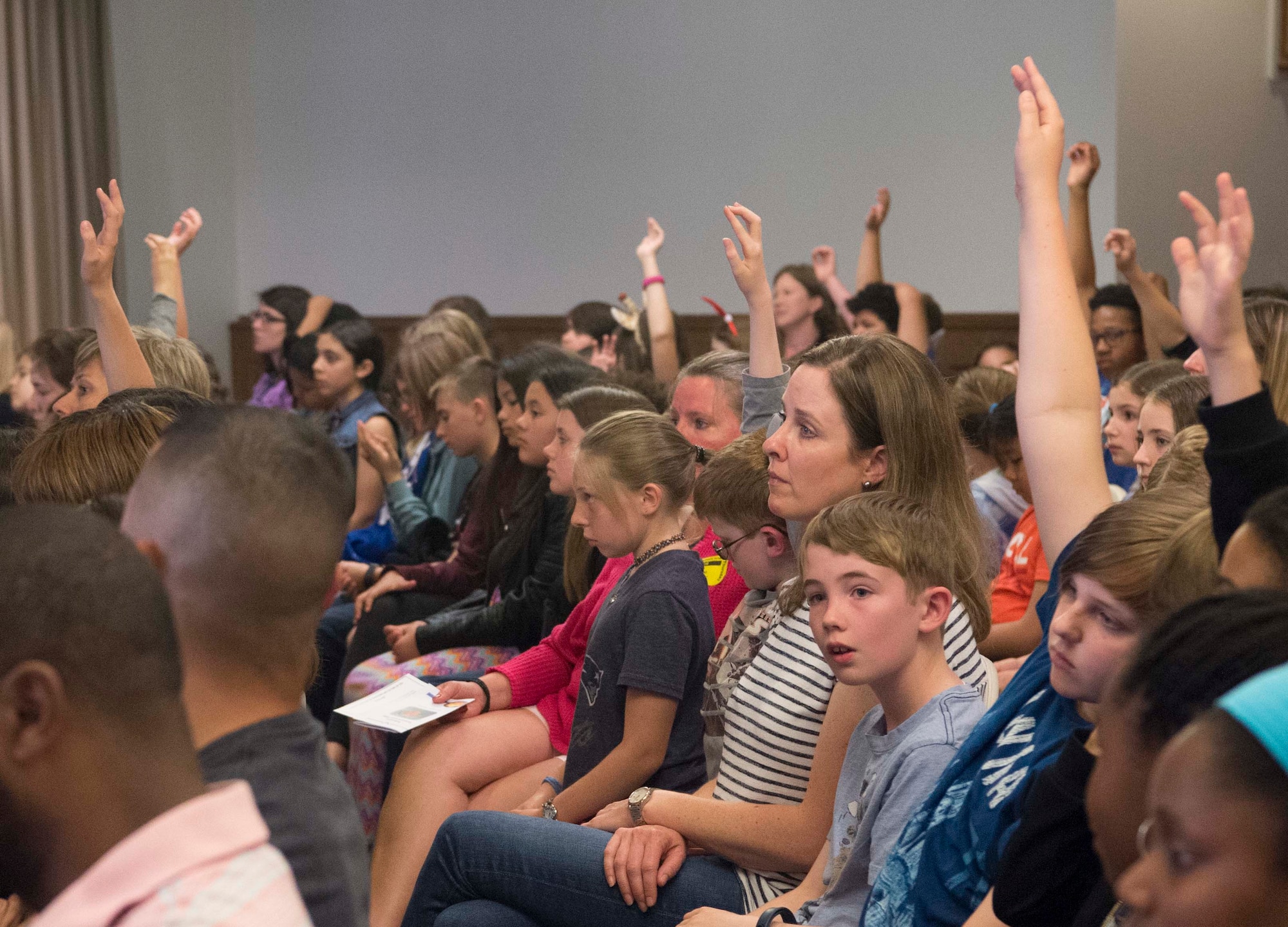 Ramstein Air Base and Vogelweh Air Station students wait to ask Joan Salter, Holocaust survivor, questions about her life as a polish Jew during the Holocaust on Ramstein Air Base, Germany, May 24, 2018. When they were young, Salter and her sister evacuated to the U.S., where an American family fostered Salter before eventually reuiniting with her parents in 1947. (U.S. Air Force photo by Senior Airman Elizabeth Baker)
