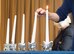 Ann Miracle, Holocaust educator, takes part in a candle lighting ceremony during the 86th Airlift Wing Holocaust Remembrance on Ramstein Air Base, Germany, May 24, 2018. The six candles represent the six million Jews and all other victims that perished during the Holocaust. (U.S. Air Force photo by Senior Airman Elizabeth Baker)