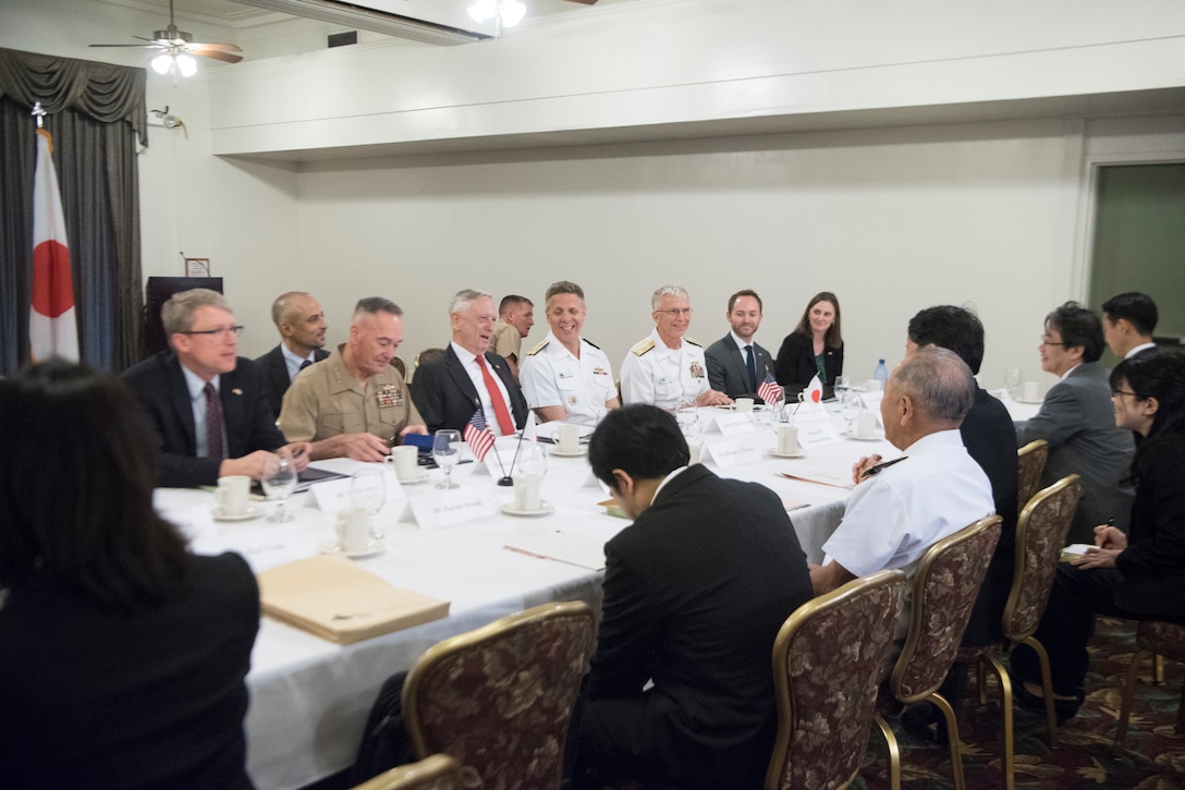 U.S. and Japanese defense leaders meet around a table in Hawaii.