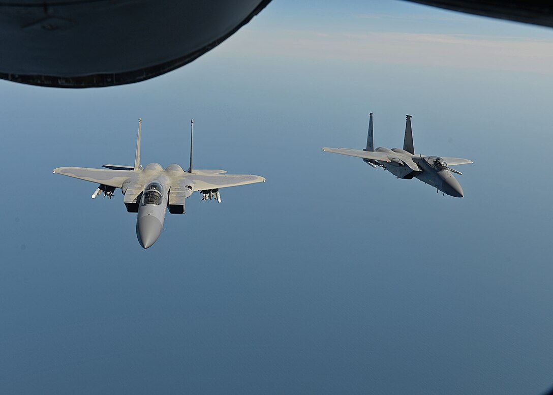 Two U.S. Air Force F-15C Eagles from RAF Lakneheath fly in a formation behind a U.S. Air Force KC-135 Stratotanker from RAF Mildenhall during Exercise Point Blank over England, May 24, 2018. The exercise is a recurring large-force exercise designed and co-hosted by the Royal Air Force and the 48th Fighter Wing. It is a low-cost initiative created to increase tactical proficiency of the Department of Defense and Ministry of Defence forces stationed within the United Kingdom and Europe. (U.S. Air Force photo by Senior Airman Luke Milano)
