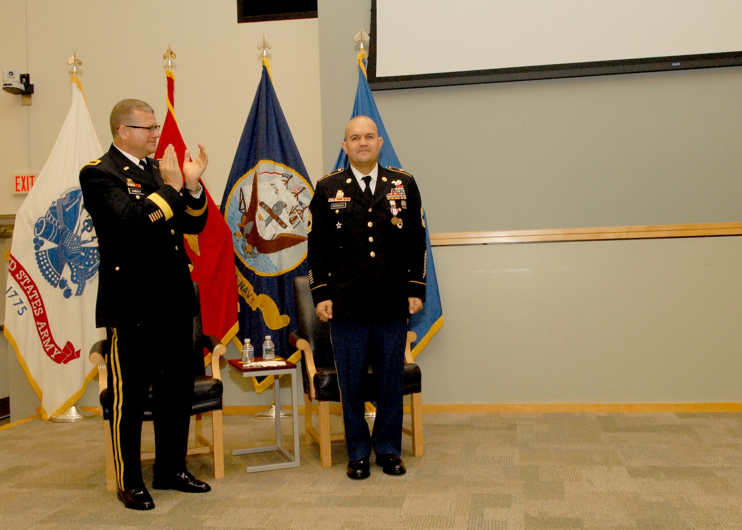 DLA Troop Support Commander Army Brig. Gen. Mark Simerly, left, applauds Senior Enlisted Advisor Army Master Sgt. Jose Moraga during a retirement ceremony in Moraga’s honor May 23, 2018 at DLA Troop Support. Moraga thanked his family, friends, and colleagues for their support and sacrifices throughout his military career and beyond.