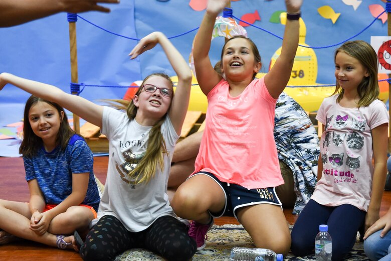 Children of command-sponsored families cheer as their team name is announced during Vacation Bible School at Al Udeid Air Base, Qatar, May 24, 2018. The two-day event, hosted by the 379th Air Expeditionary Wing Chaplain Corps, integrated biblical lessons and team-building activities. (U.S. Air Force photo by Staff Sgt. Enjoli Saunders)