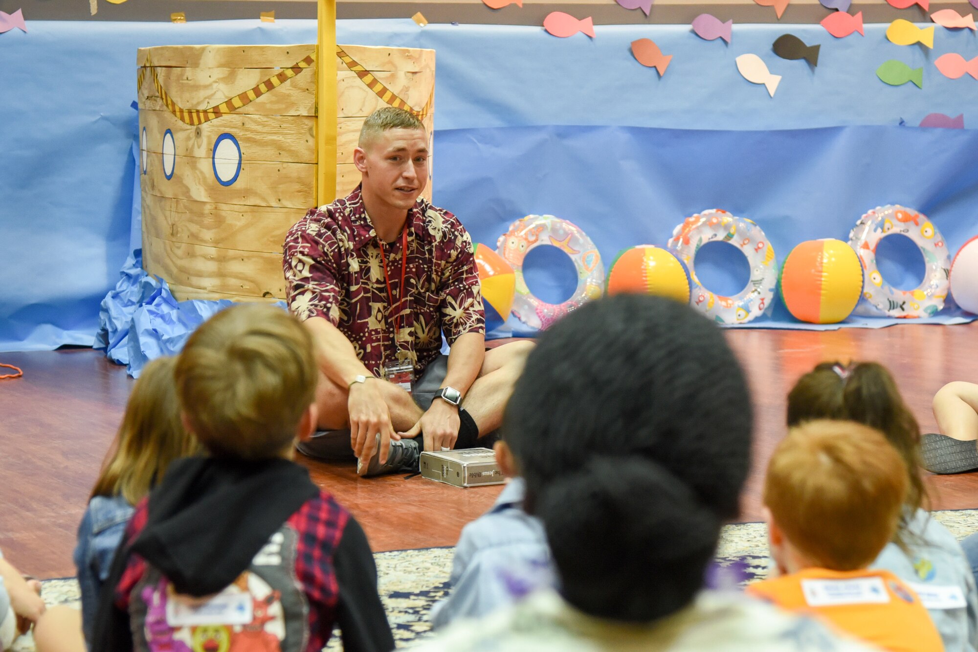 Senior Airman Corey Barton, a volunteer at Vacation Bible School, teaches a Bible lesson to children of command-sponsored families at Al Udeid Air Base, Qatar, May 24, 2018. The two-day event, hosted by the 379th Air Expeditionary Wing Chaplain Corps, integrated biblical lessons and team-building activities. (U.S. Air Force photo by Staff Sgt. Enjoli Saunders)