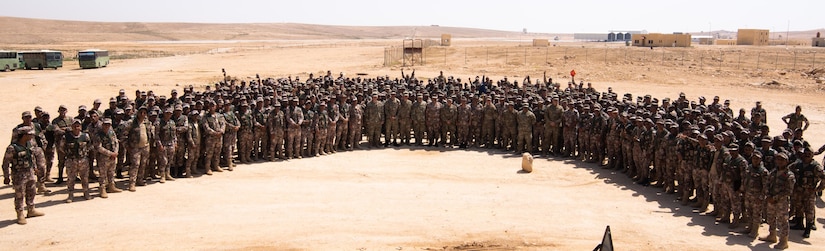 Soldiers with the Jordan Armed Forces and U.S. Army celebrate the graduation of soldiers from the Jordan Operational Engagement Program on April 29, 2018. The nine-week program trained soldiers from the 11th Battalion, Border Guard forces, JAF, on a collection of soldier skills like mortar firing and combat life-saver.