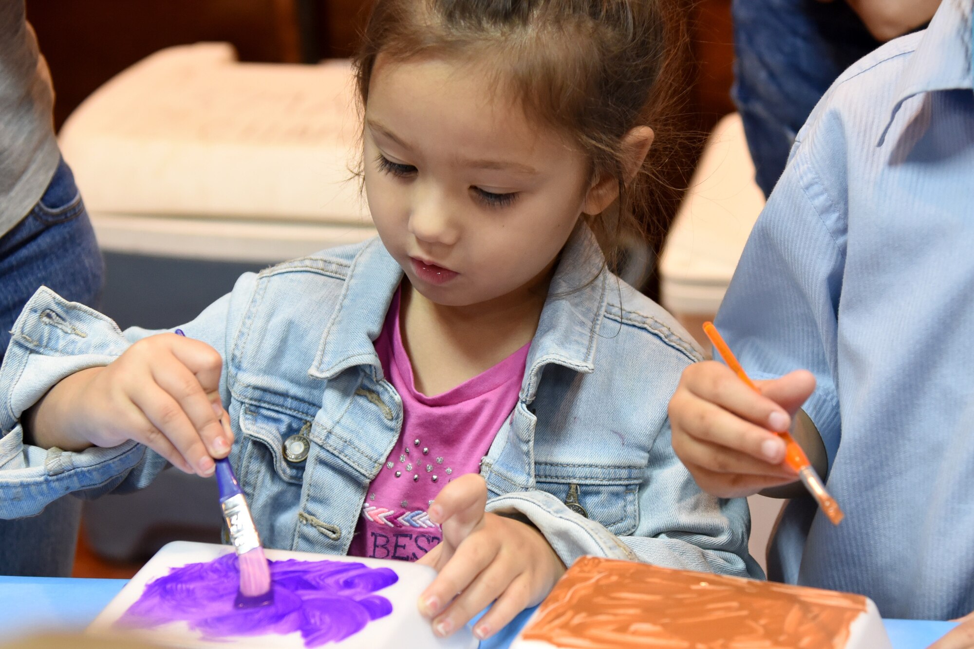 Children of command-sponsored families paint during Vacation Bible School at Al Udeid Air Base, Qatar, May 24, 2018. The two-day event, hosted by the 379th Air Expeditionary Wing Chaplain Corps, integrated biblical lessons and team-building activities. (U.S. Air Force photo by Staff Sgt. Enjoli Saunders)