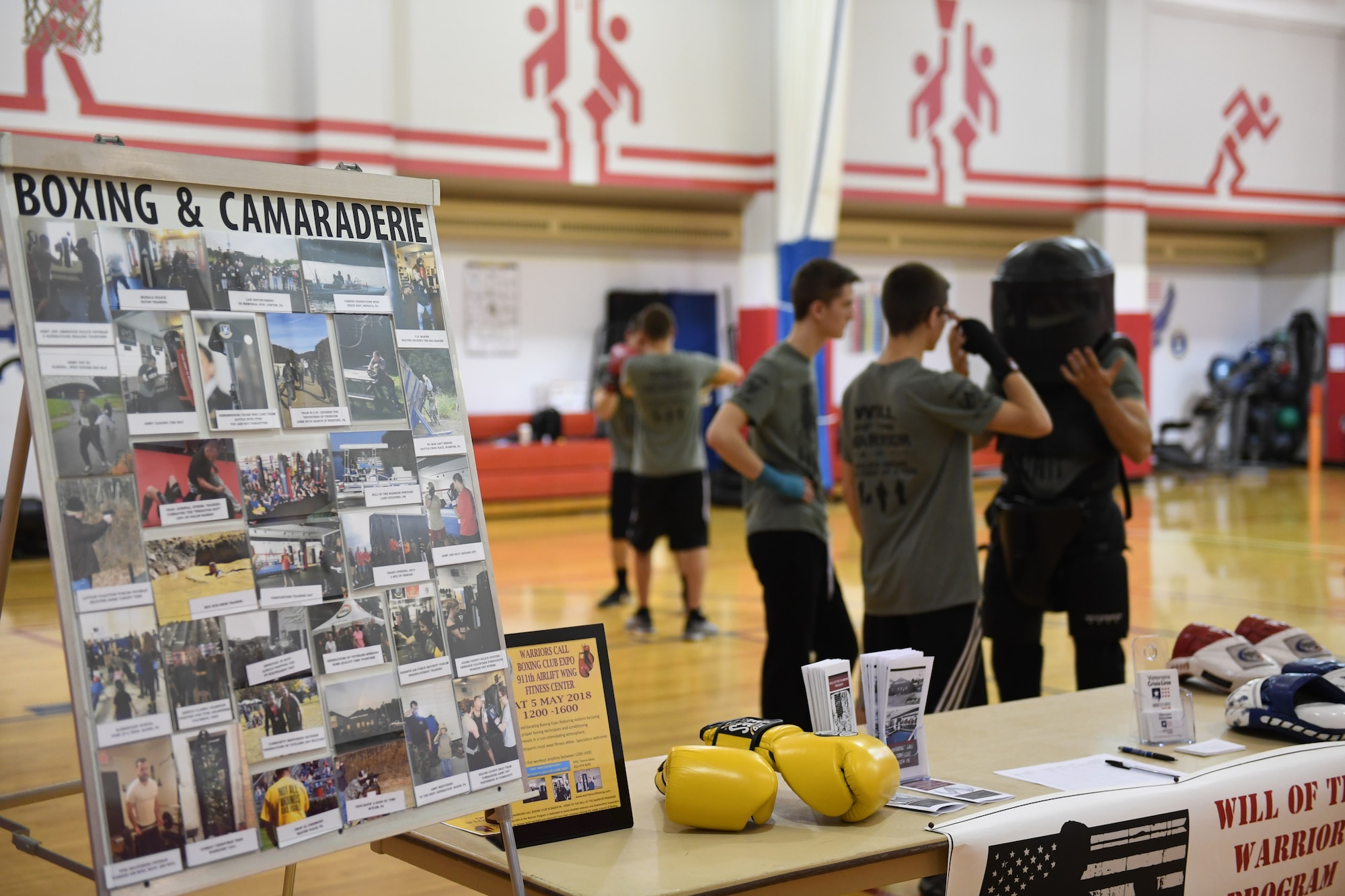 Members of the Warriors' Call Boxing Club in Braeden, Pennsylvania, talk about the Boxing and camaraderie event at the Fitness Center at the Pittsburgh International Airport Air Reseve Station, Pennsylvania,  May 5, 2018. The purpose of the event is to get Airmen interested in the club's Will of the Warrior Program, which is a program for any person who is serving or has served in the U.S. military to relieve stress and help with PTSD. (U.S. Air Force Photo by Airman 1st Class Grace Thomson)