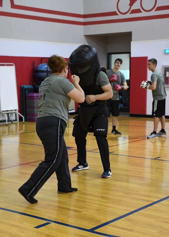 Brandy Horchak-Jeusjekova and Vitalijs Jeusjekovs, founders of the Will of the Warrior program and Warriors' Call Boxing Club in Braeden, Pennsylvania, practice basic boxing moves at the Fitness Center at the Pittsburgh International Airport Air Reserve Station, Pennsylvania, May 5, 2018. The suit Jeusjekovs is wearing is mainly used to teach sexual assult prevention classes. (U.S. Air Force Photo by Airman 1st Class Grace Thomson)