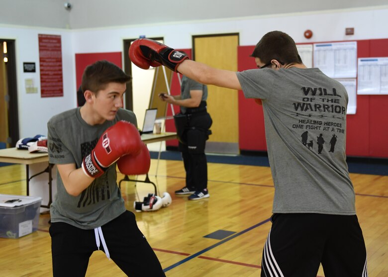 Ethan Conrad, student at the Ambridge Area Junior High School in Freedom, PA, and Nathan Erickson, student at the Ambridge Area Senior High School in Ambridge, Pennsylvania, practice dodging punches at the Fitness Center at the Pittsburgh International Airport Air Reserve Station, Pennsylvania, May 5, 2018. They also demonstraed basic boxing moves during the practice for onlookers. (U.S. Air Force Photo by Airman 1st Class Grace Thomson)