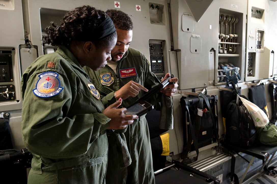 Air Force pilot and technician discuss procedures.
