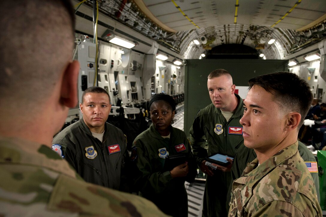 An airman briefs aeromedics and pilot on load plan.