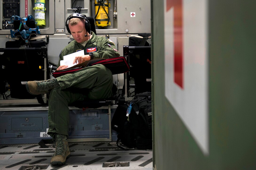 An airman reviews mission details for an aeromedical evacuation mission.