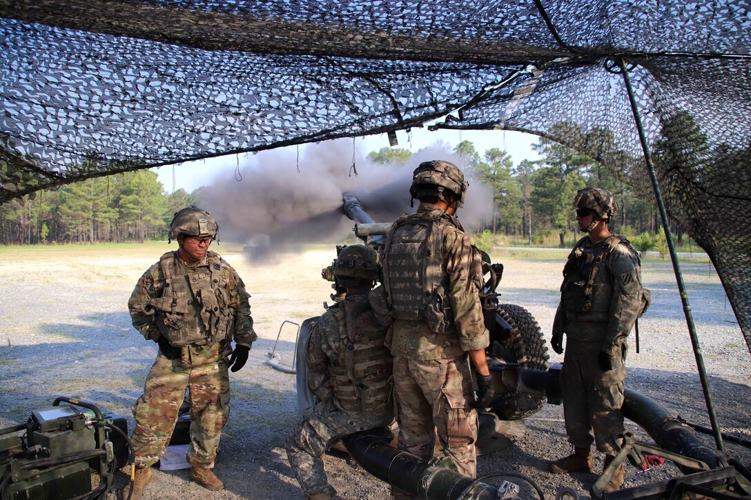 Soldiers fire a howitzer during a live-fire exercise.