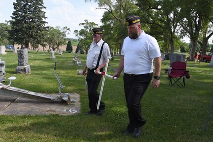 Alan Gransey (left), American Legion Post 56 vice commander, and Marc Tucker, American Legion Post 56 commander, carry a cross during a Memorial Day ceremony at Oak Hill Cemetery, May 28, 2018, in Plattsmouth, Neb.