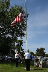 Alan Gransey (left), American Legion Post 56 vice commander, and Marc Tucker, American Legion Post 56 commander, raise the American flag during a Memorial Day ceremony at Oak Hill Cemetery, May 28, 2018, in Plattsmouth, Neb.