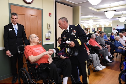 U.S. Army Maj. Gen. Daniel Karbler, U.S. Strategic Command chief of staff, greets a veteran during the Eastern Nebraska Veterans’ Home Memorial Day ceremony, May 28, 2018, in Bellevue, Neb.