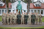 81st Stryker Brigade Combat Team members and three officers from the Royal Thai Army pose for a photo by the Washington National Guard headquarters building on Camp Murray, Wash. on April 5, 2018.