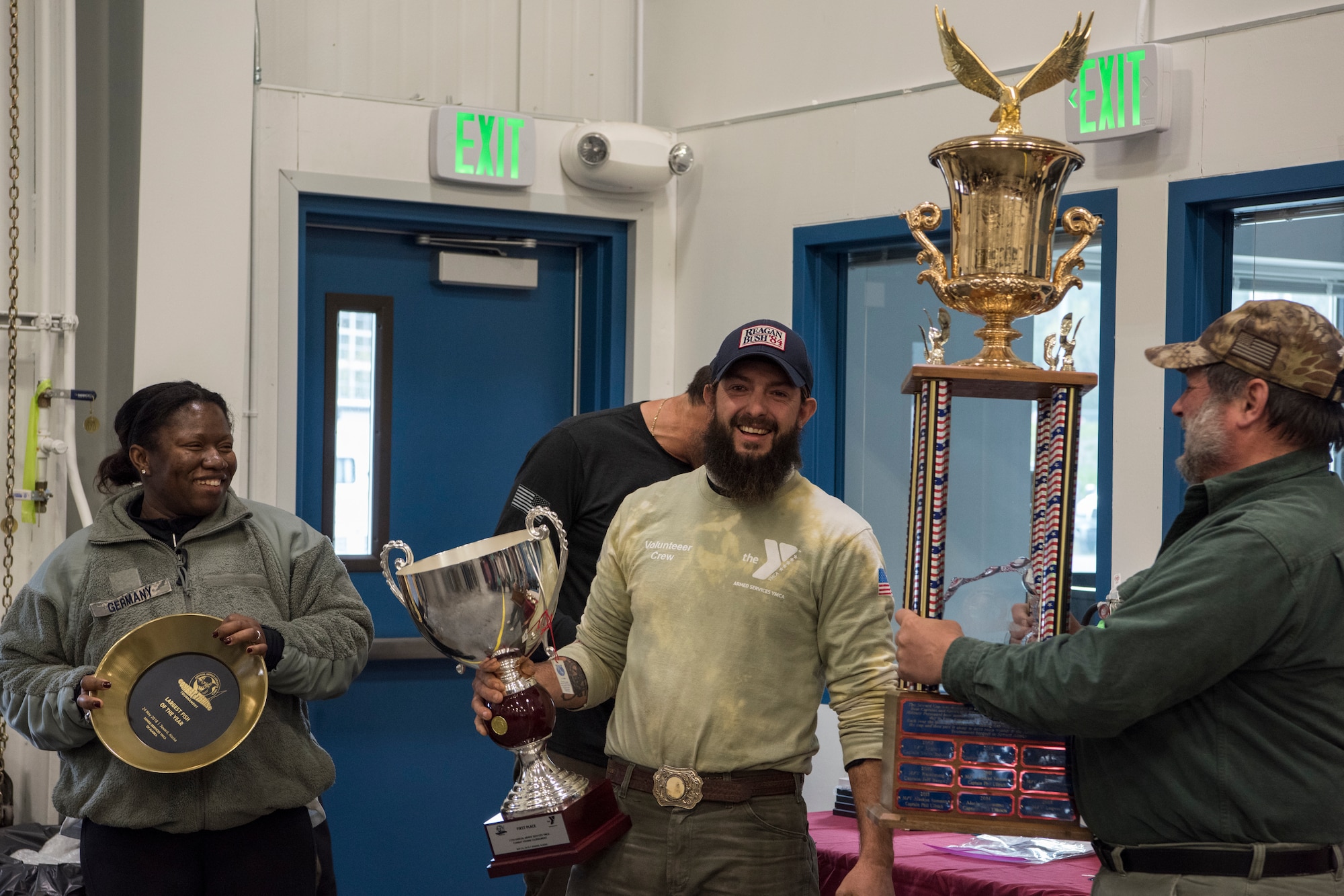 U.S. Air Force Staff Sgt. Yvette Germany, a 673d Medical Group administrative technician, stands with William Gentry, captain of the vessel ‘Predator,’ as they receive the first place trophy from ‘Nauti Girl’ Capt. John Moline for largest fish during the 2018 Armed Services YMCA of Alaska Combat Fishing Tournament in Seward, Alaska, May 24, 2018. The winning fish weighed in at 90.7 pounds. This is Germany’s first time participating in the tournament. The tournament was established as a way of showing thanks and honor to service members through an opportunity to go deep-sea fishing.