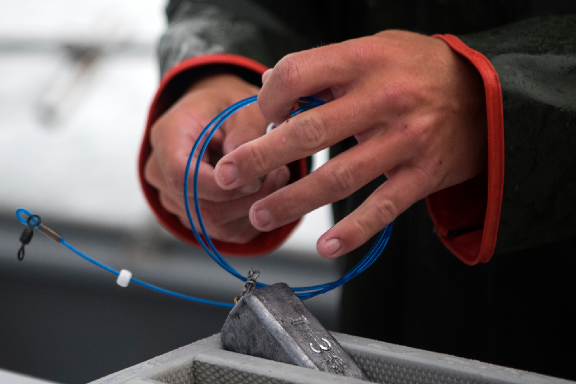 Justin Leonard, crew member of the Puffin Fishing Charter vessel ‘Tenacious,’ puts a sinker on a line during the 2018 Armed Services YMCA of Alaska Combat Fishing Tournament in Seward, Alaska, May 24, 2018. Founded in 2006, the tournament was established as a way of showing thanks and honor to service members through an opportunity to go deep-sea fishing. Because of community support and the volunteerism of the more than 660 crew members and 275 professional fishing charters supplying their time and services, more than 2,400 currently serving military personnel have been able to participate since its inception.