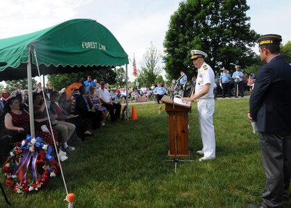 U.S. Navy Capt. Brook DeWalt, U.S. Strategic Command chief of public affairs, speaks about honoring the spirit of all those who died while serving our nation during a Memorial Day service at Forest Lawn Memorial Park in Omaha, Neb., May 28, 2018.
